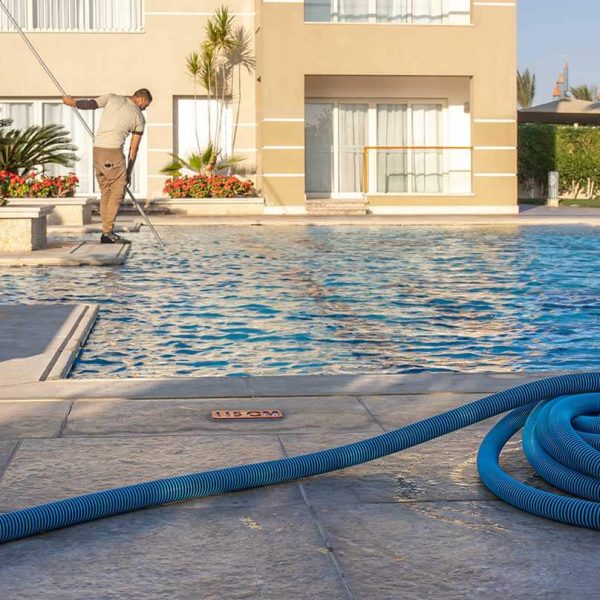 man cleaning pool Aquazul pool repair in las vegas